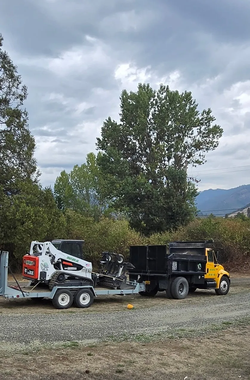 Bobcat on the trailer being hauled by the dumptruck